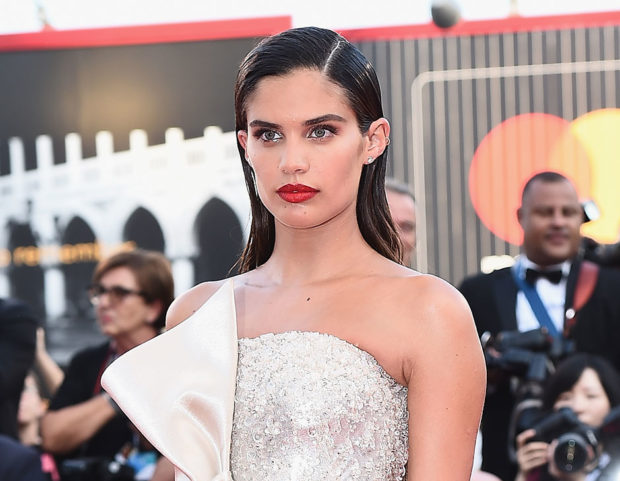 Capelli wet con riga centrale e labbra rosse ad alto impatto per Sara Sampaio. Make up by Giorgio Armani Beauty. Photo credit: Getty Images